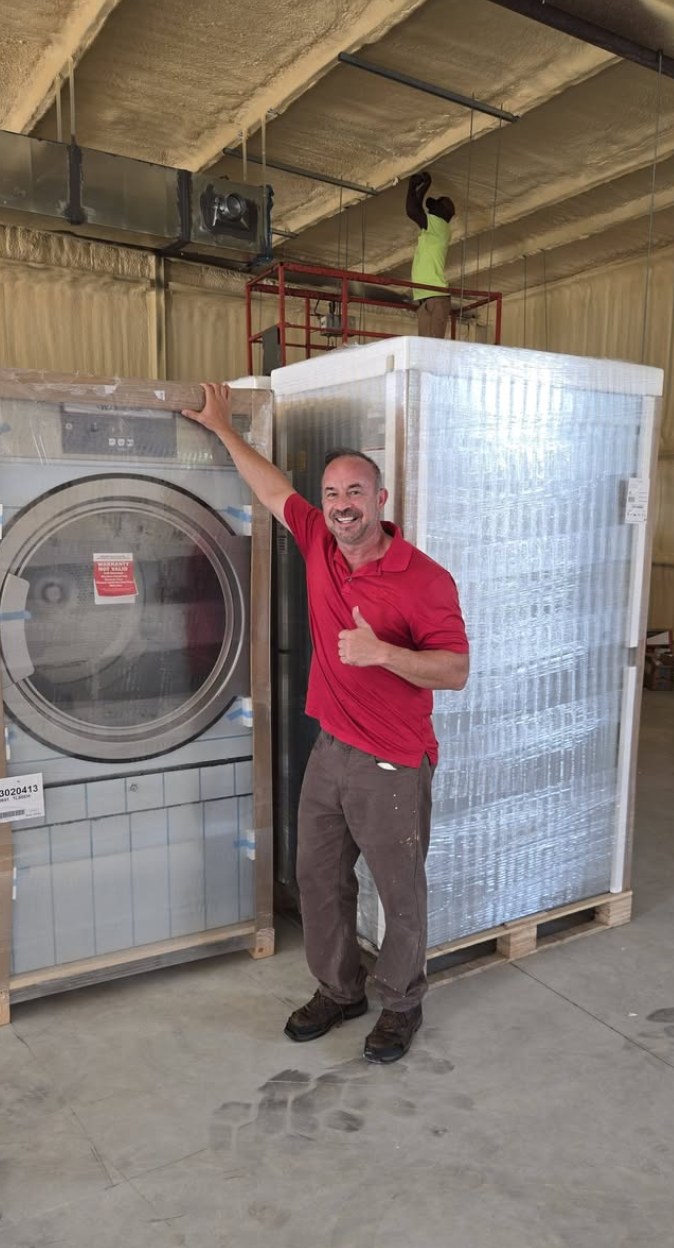 A brand-new commercial washer being installed at the Chiefland store